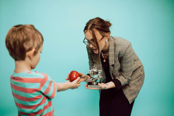 Boy offering an apple