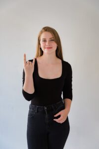 Portrait of Smiling Woman Showing Sign Language