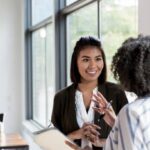 mature manager gives praise to mid adult employee - employee engagement stock pictures, royalty-free photos & images