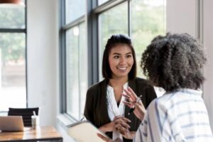 mature manager gives praise to mid adult employee - employee engagement stock pictures, royalty-free photos & images
