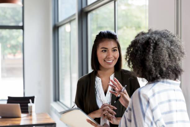 mature manager gives praise to mid adult employee - employee engagement stock pictures, royalty-free photos & images