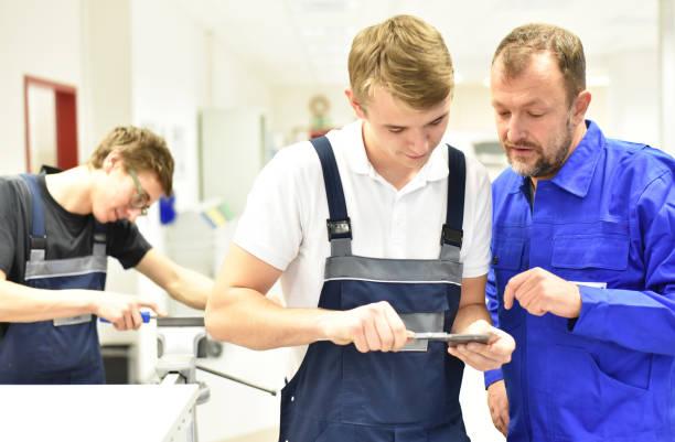 Group of young people in technical vocational training with teacher Group of young people in technical vocational training with teacher vocational training stock pictures, royalty-free photos & images