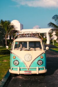 Classic vintage van parked on a sunny Anguilla driveway, surrounded by palm trees.