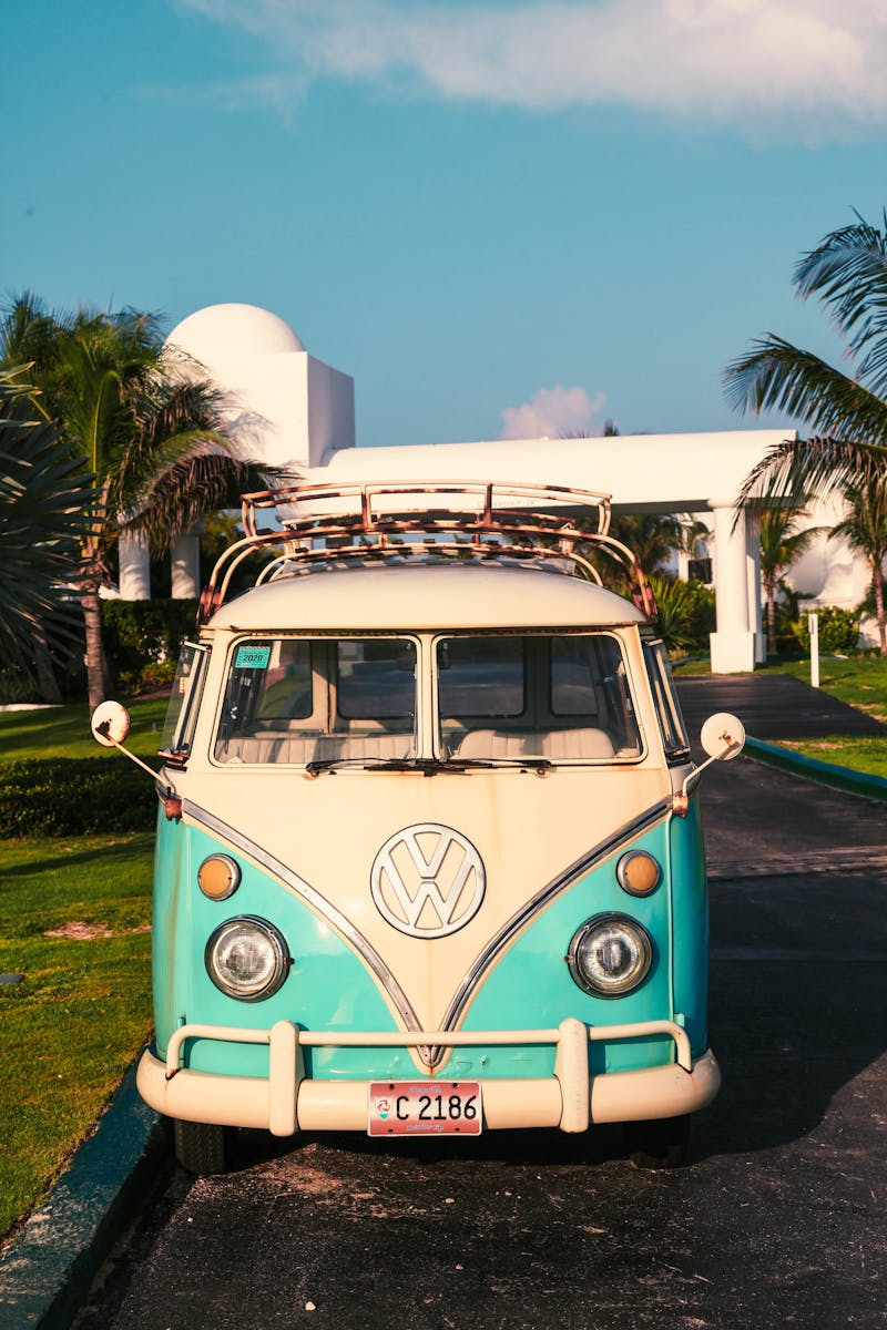 Classic vintage van parked on a sunny Anguilla driveway, surrounded by palm trees.